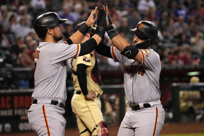 SF Giants corner infielders David Villar and J.D. Davis high-ten after a home run against the Diamondbacks. (2022)